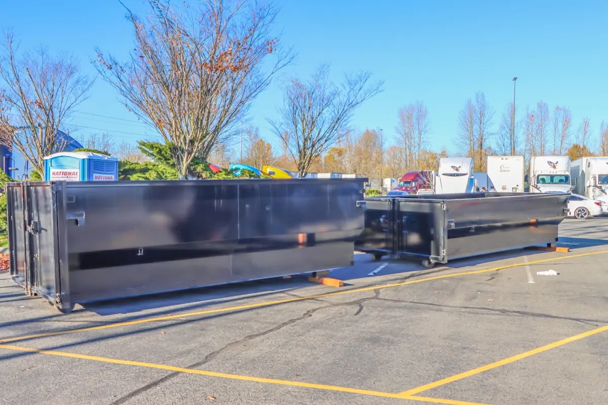 Professional dumpster rental service with roll-off container on residential driveway in West Hartford